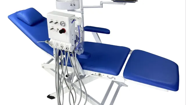 Blue dental chair with attached dental unit and operating light