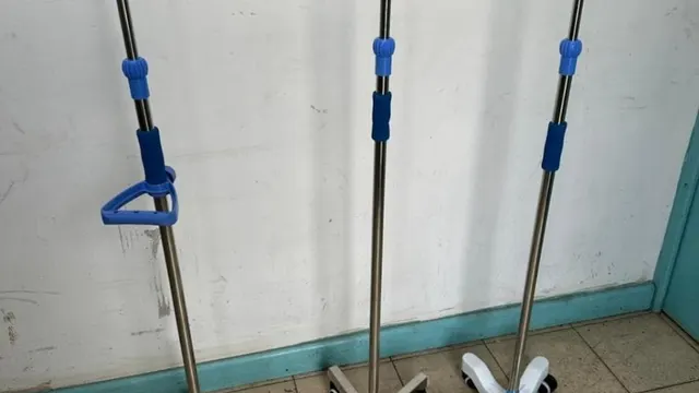 Three stainless steel drip stands on wheeled bases