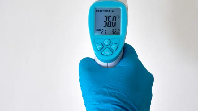 Infrared thermometer being held to take a temperature reading